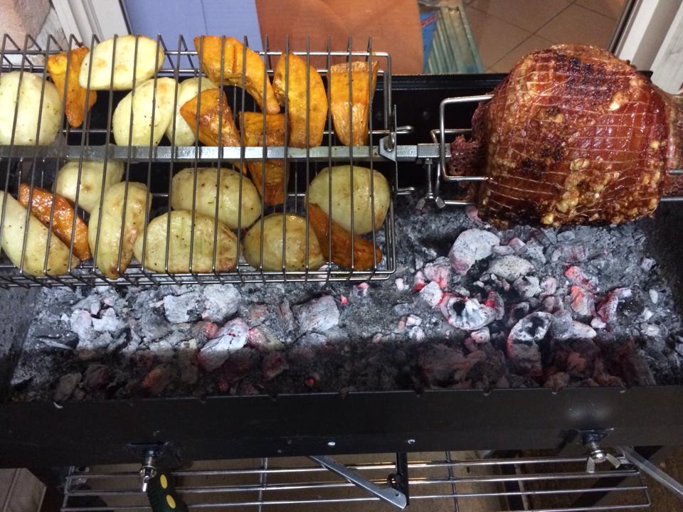 Pork and veggies cooking on a Cyprus Spit Roaster
